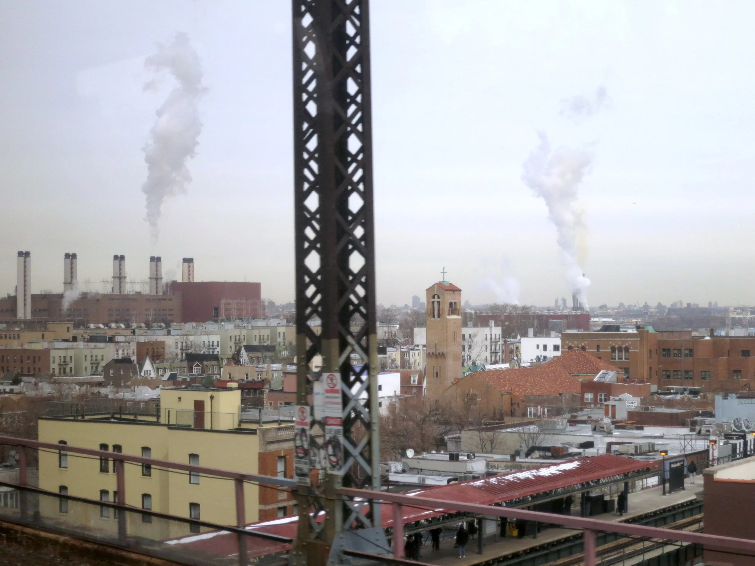 Clouds of smoke rise from industrial buildings in Queens, NY. If these emissions aren’t curbed in the next four years, property owners will face penalties. Source: Public Good