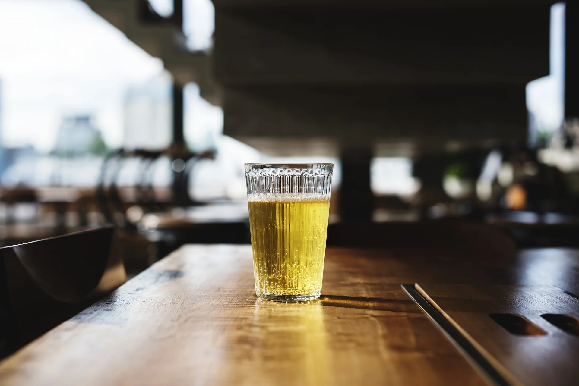 Glass of beer on bar.jpg