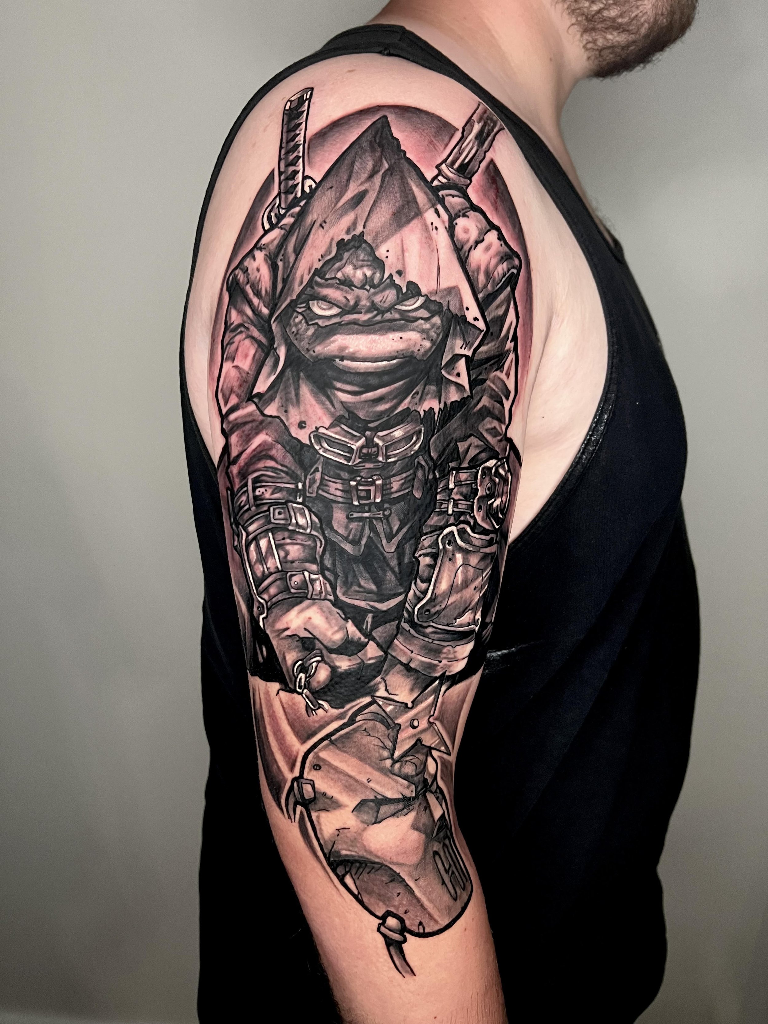 Black and grey Atlas tattoo on the inner forearm.