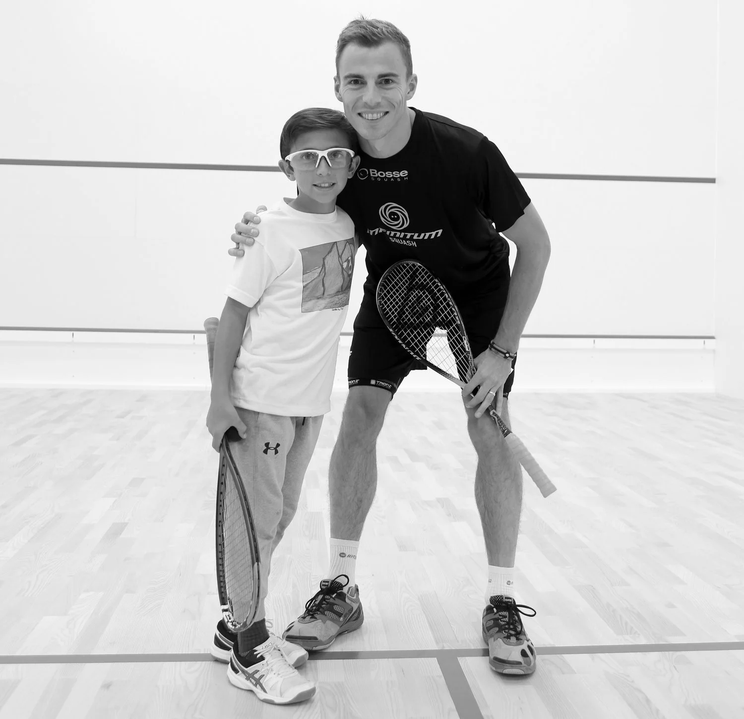 INFINITUM Squash Junior Academy player, Max Crowe. Pictured here at the INFINITUM Squash Opening Exhibition in October with 3X World Champion, Nick Matthew.