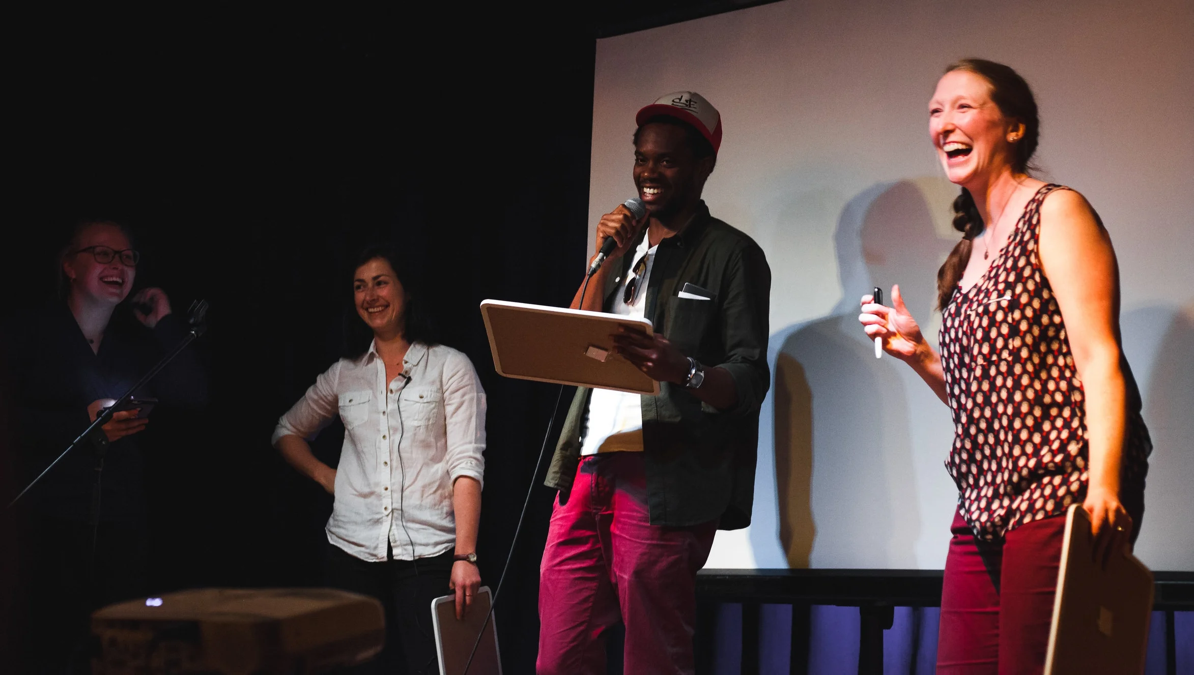 Science presenters laughing on stage.png