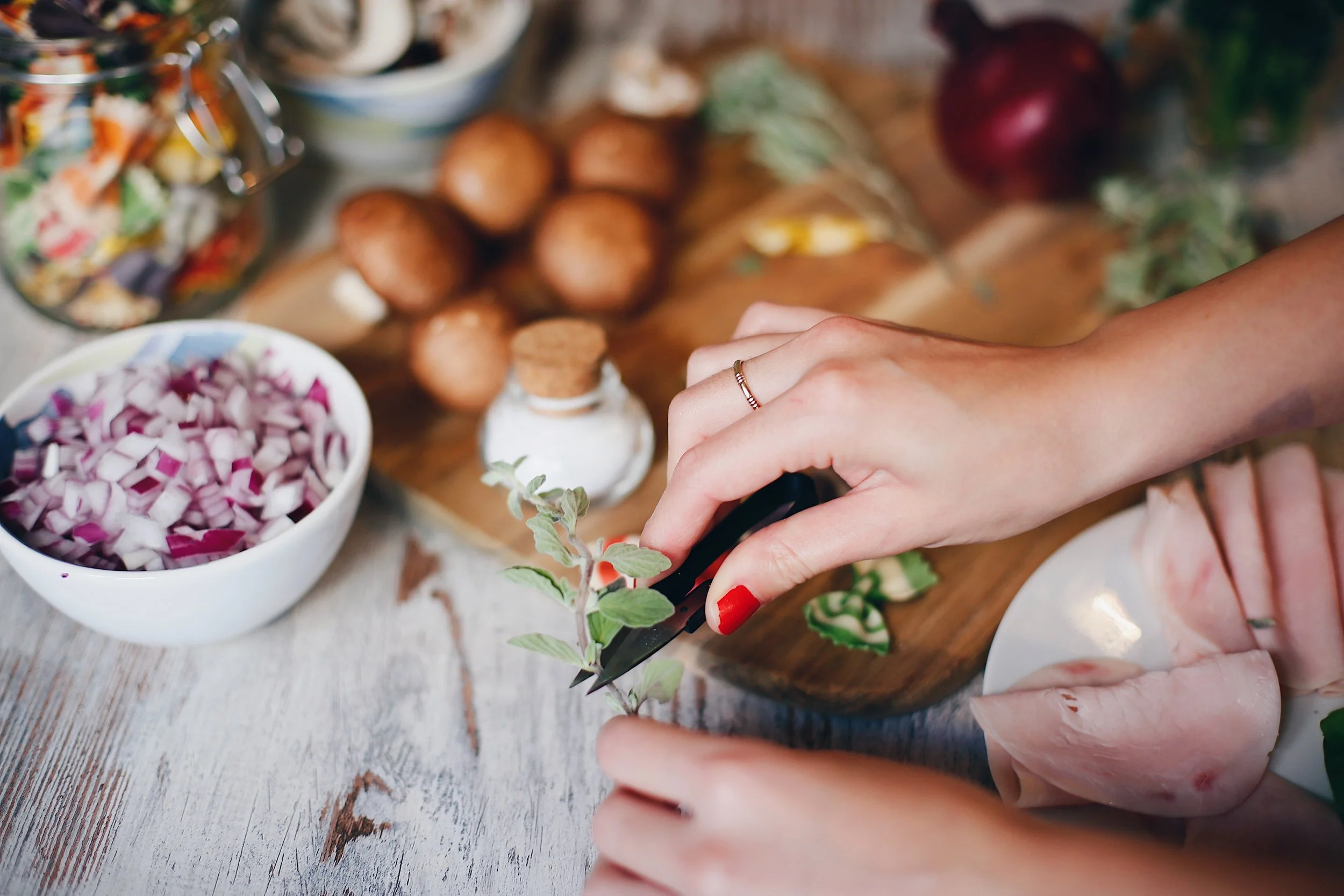  usage of a small scissors to cut the parsil. 