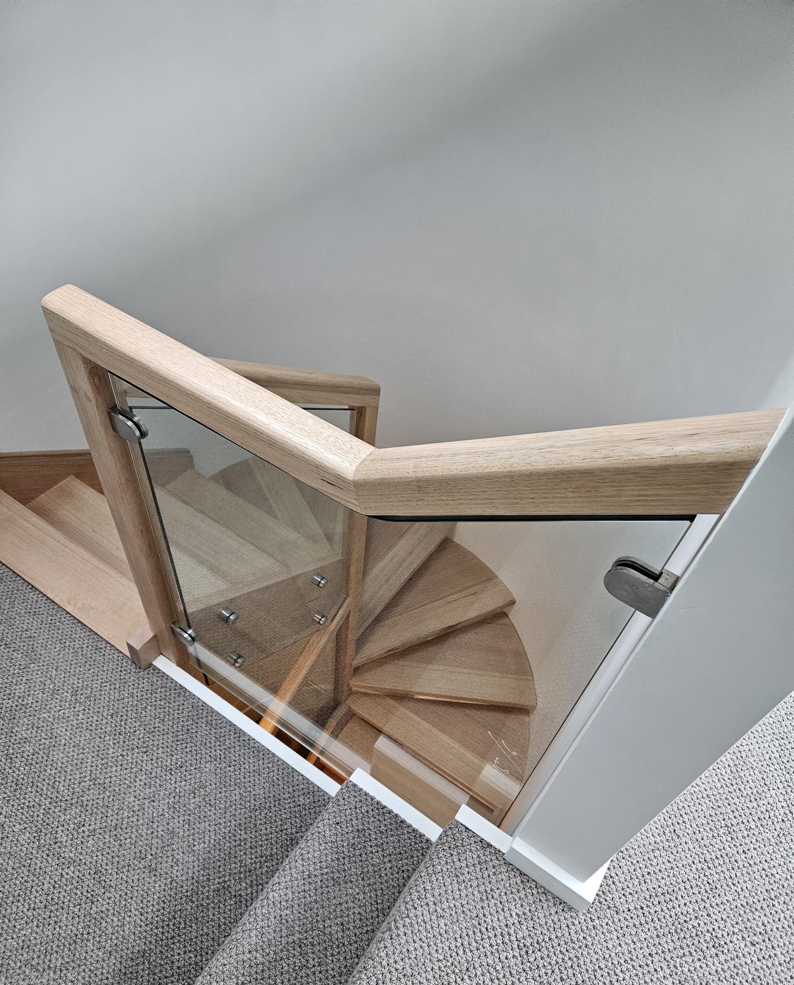  Oak handrail on point-fixed glass panels above an oak winder staircase, Northern Beaches 