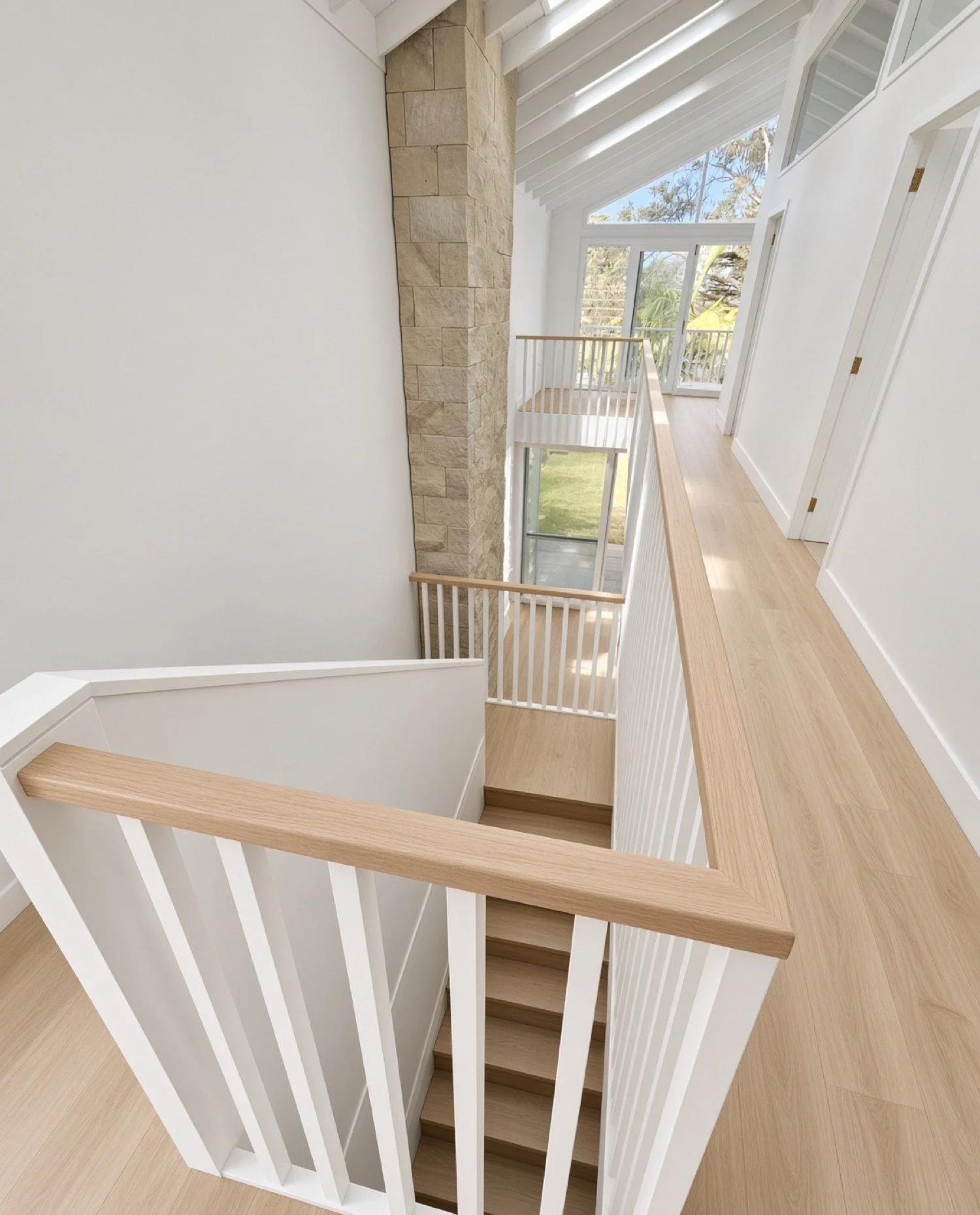 Upstairs landing with white balusters and a wide oak handrail beside a sandstone feature wall, Sydney 