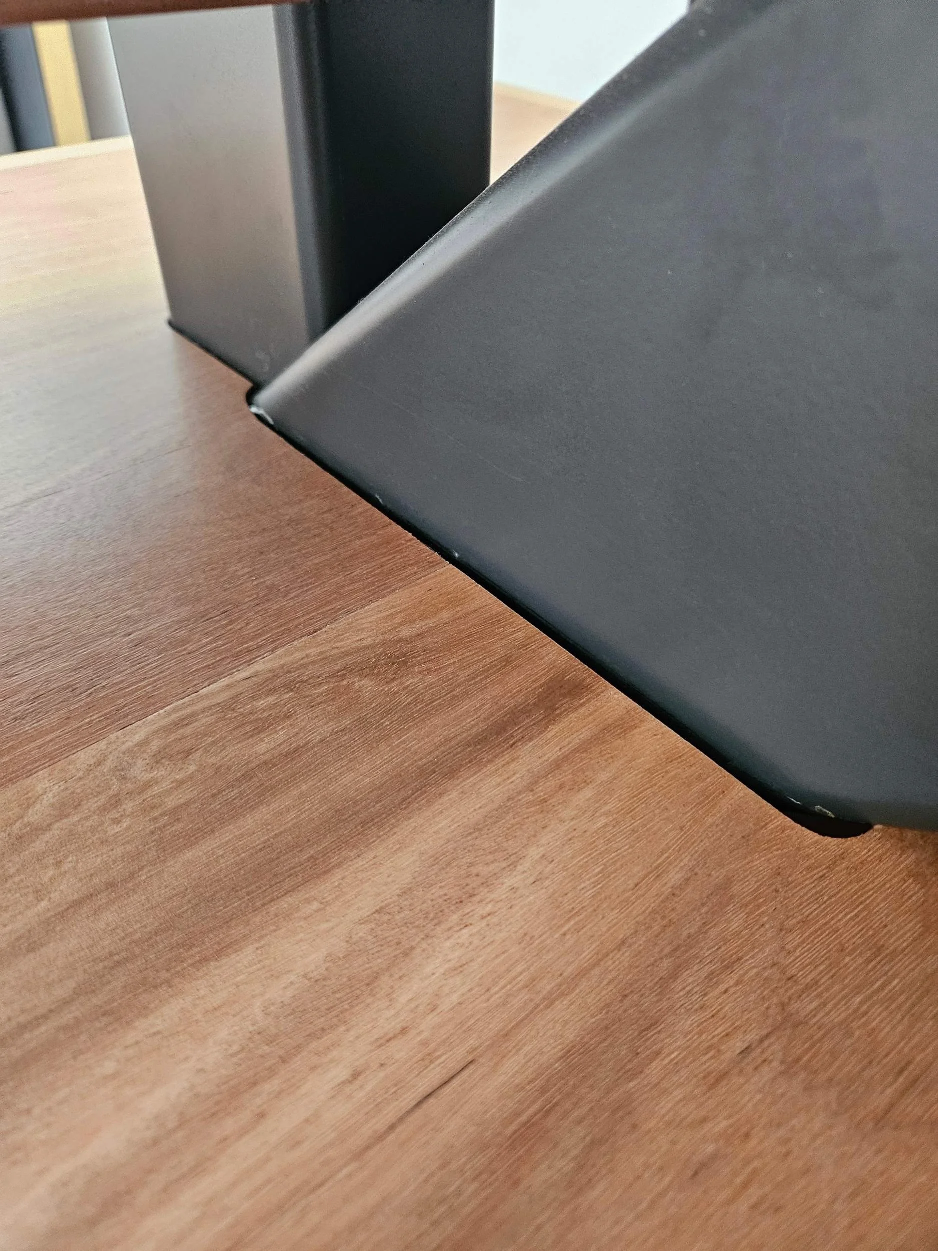 Close-up of a black steel mono-stringer passing through a cut-out in a timber tread, Sydney