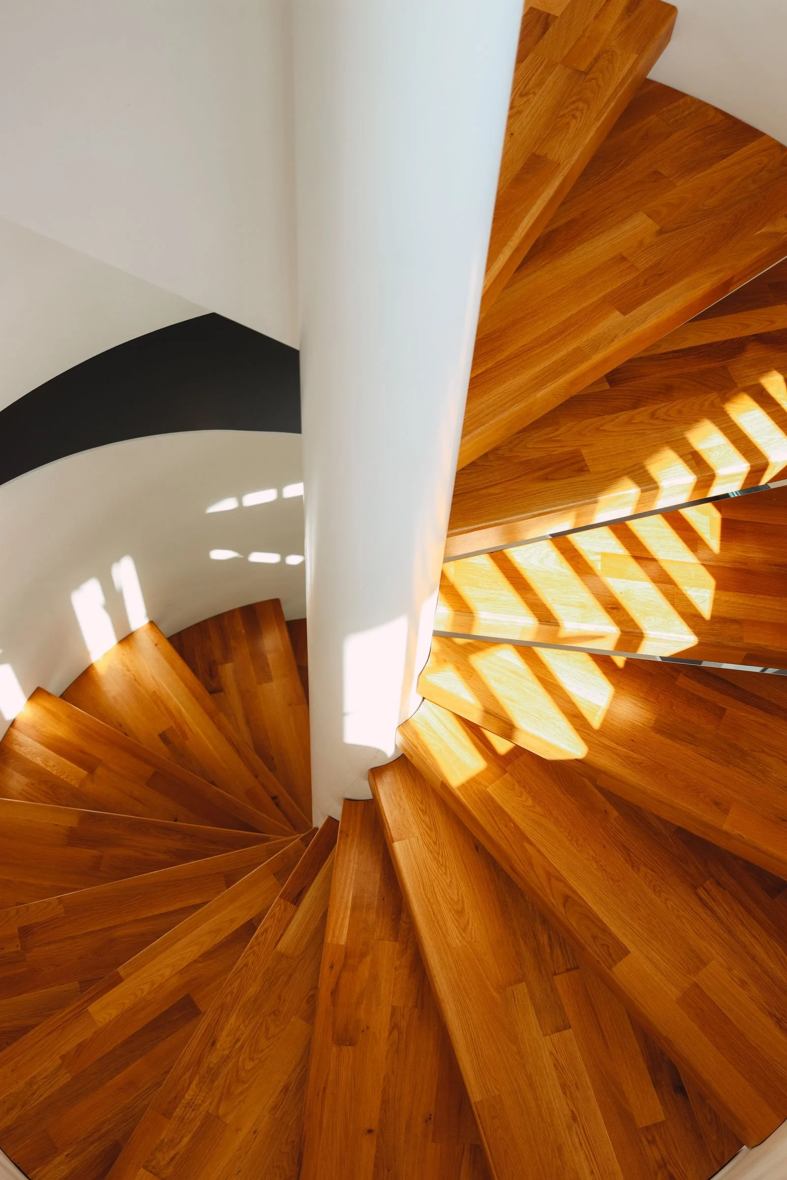 Stock photo: timber stair treads curving around a white column