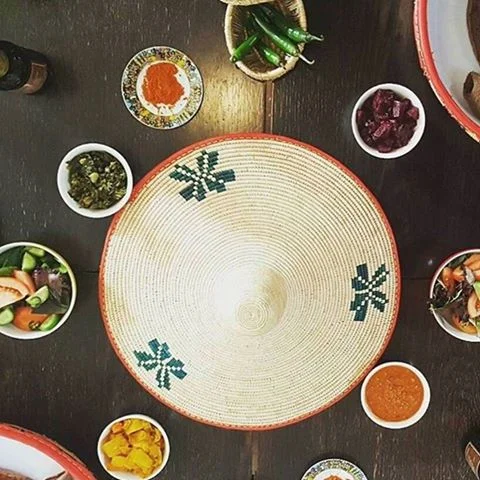 Mesob surrounded by dishes.jpg