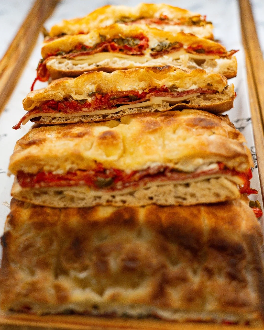 Layers of roasted peppers, salami,  oozing cheese and golden crust&hellip; every fold is pure indulgence. 

This is not just lunch. This is tradition stacked high.

📍 Join us on tour and eat like a local. Do you have plans these school holidays?

Av