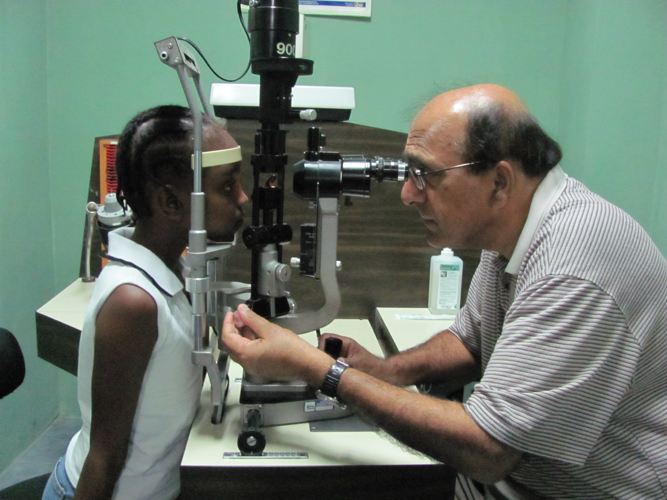 Dr. Lal with a patient in Haiti