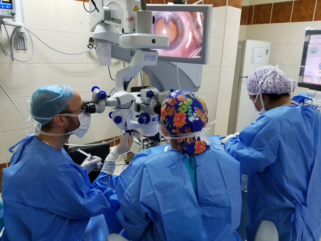 Dr. Kresch at the microscope in the operating room in Trujillo, Peru