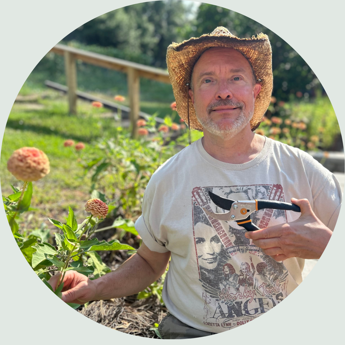 The Nurse Farmer cutting Zinnias in his garden using joint-friendly pruning shears.