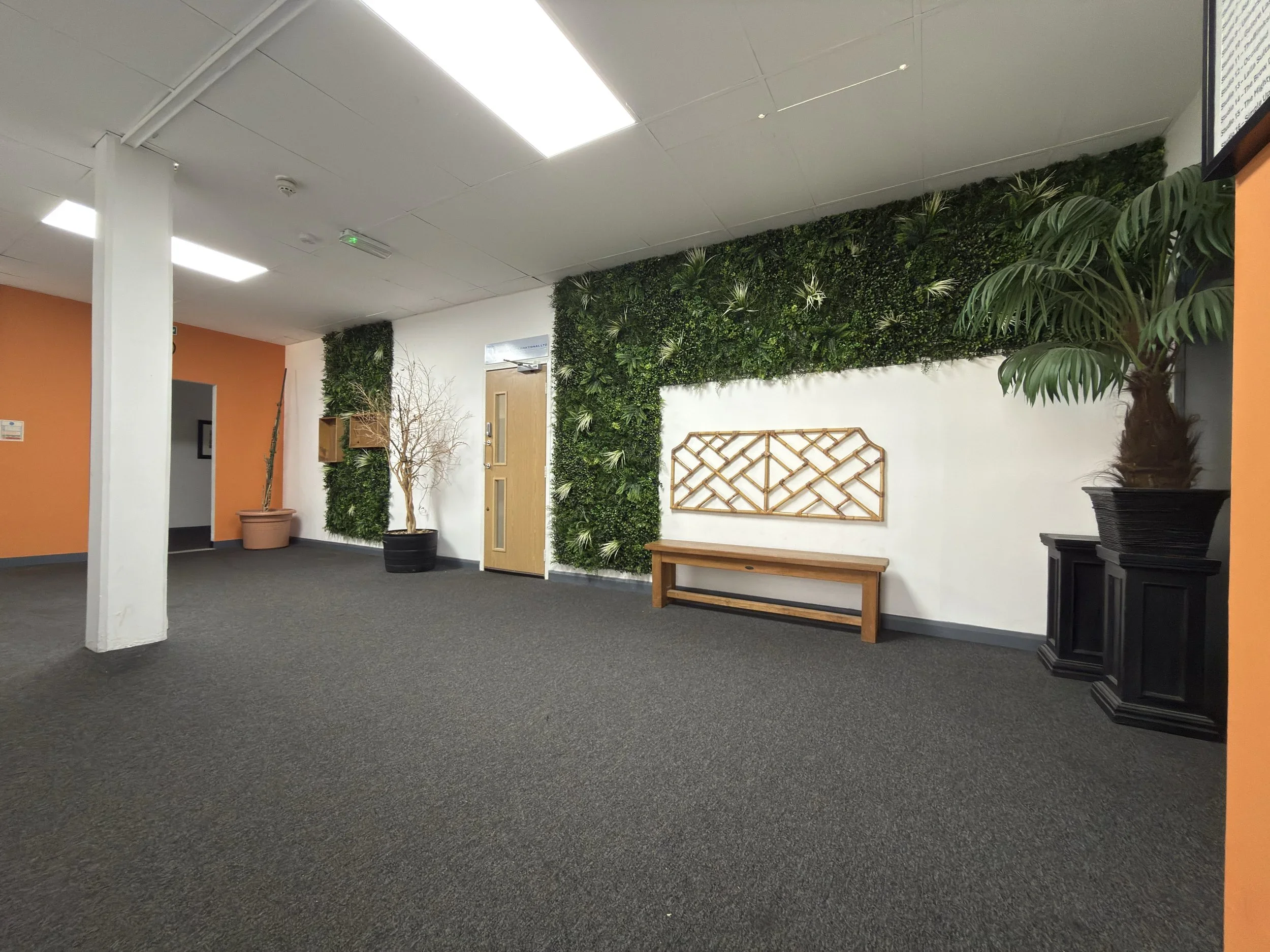 Modern office interior with green living walls and seating