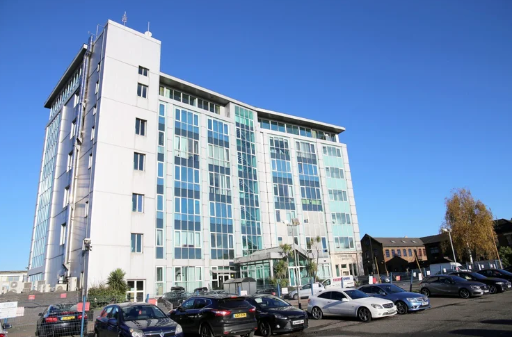 Modern office building in White City with parking area
