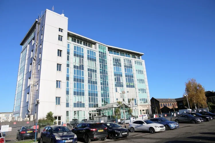 Modern commercial office building with parking area