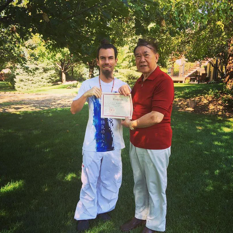 Fabrice Piché receiving his certification from Lin Housheng