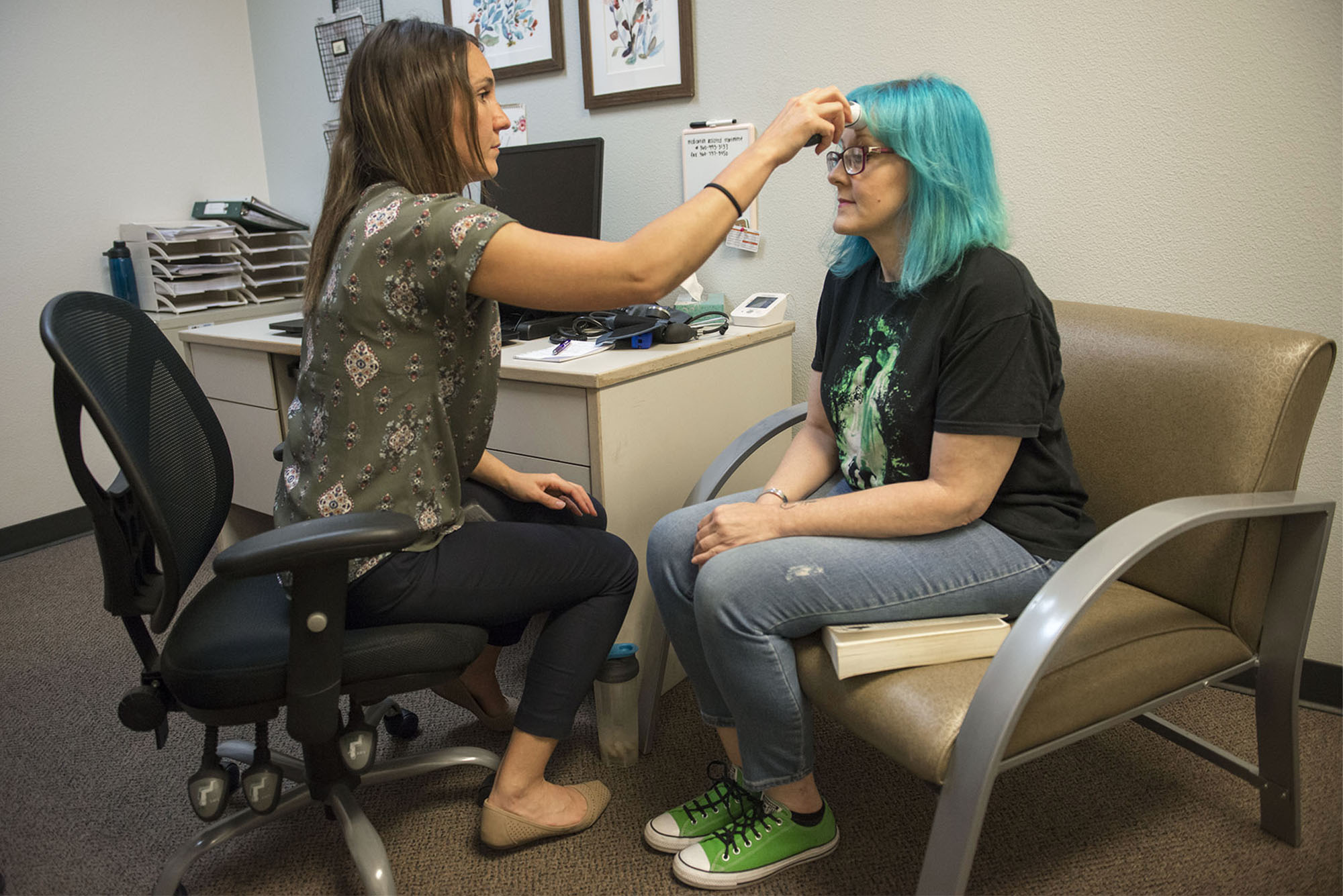  Nurse Care Manager Lessa Mercer at Columbia River Mental Health Services takes Timberly Eyssen's temperature during a medical checkup to track how the Suboxone is working for Eyssen on Monday, July 9, 2018.  