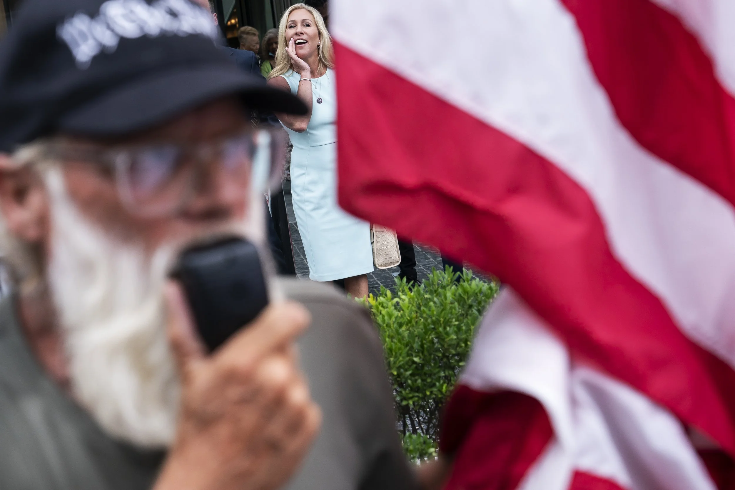  U.S. Rep. Marjorie Taylor Greene (R-GA) calls to supporters of former President Trump outside the America First Agenda Summit on July 26, 2022 in Washington, DC. Trump returned to Washington to deliver the keynote closing address at the summit.  