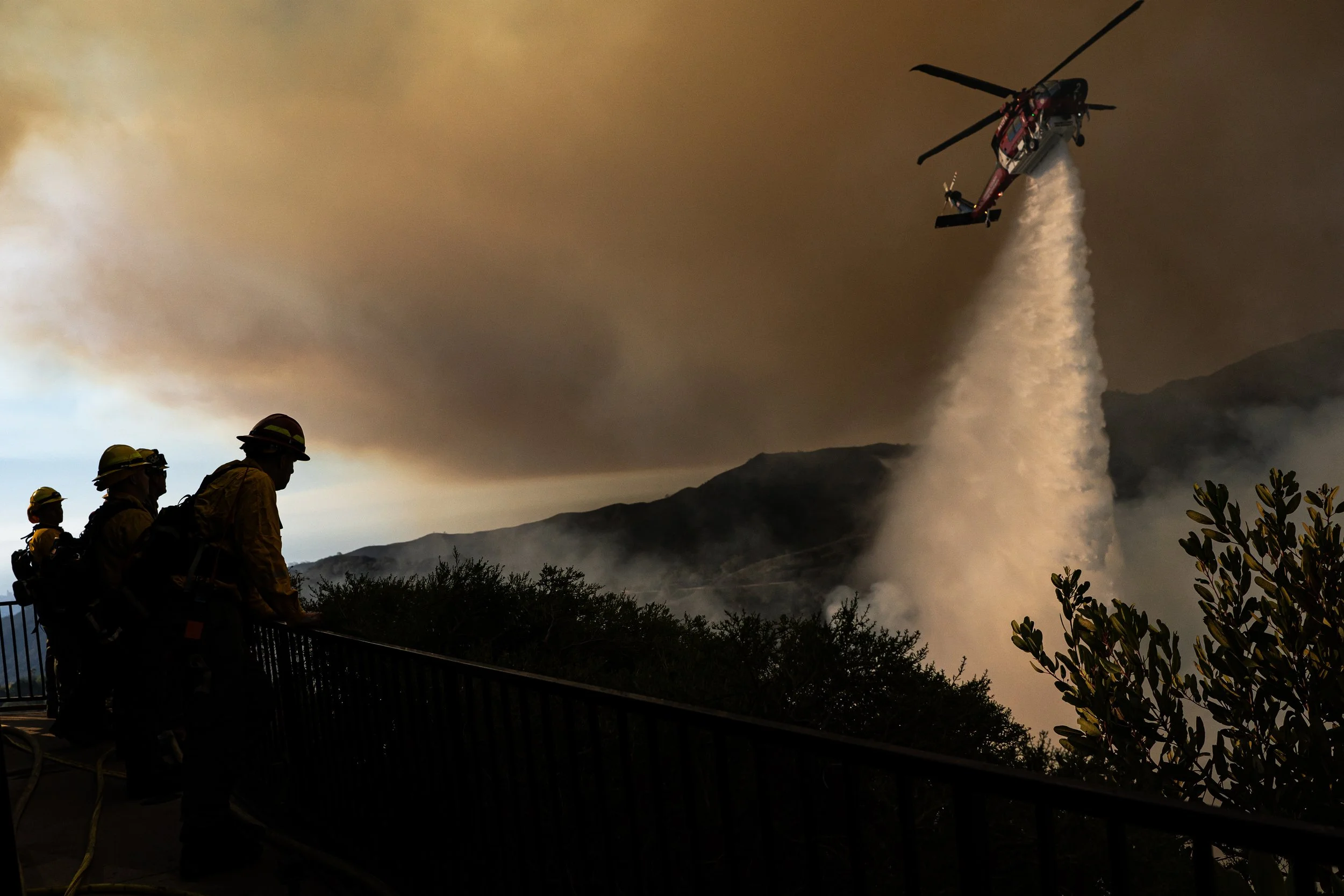  Los Angeles County Firefighters work to contain the Palisades Fire as it threatens homes near Mandeville Canyon in Los Angeles, California on Saturday, January 11, 2025.   