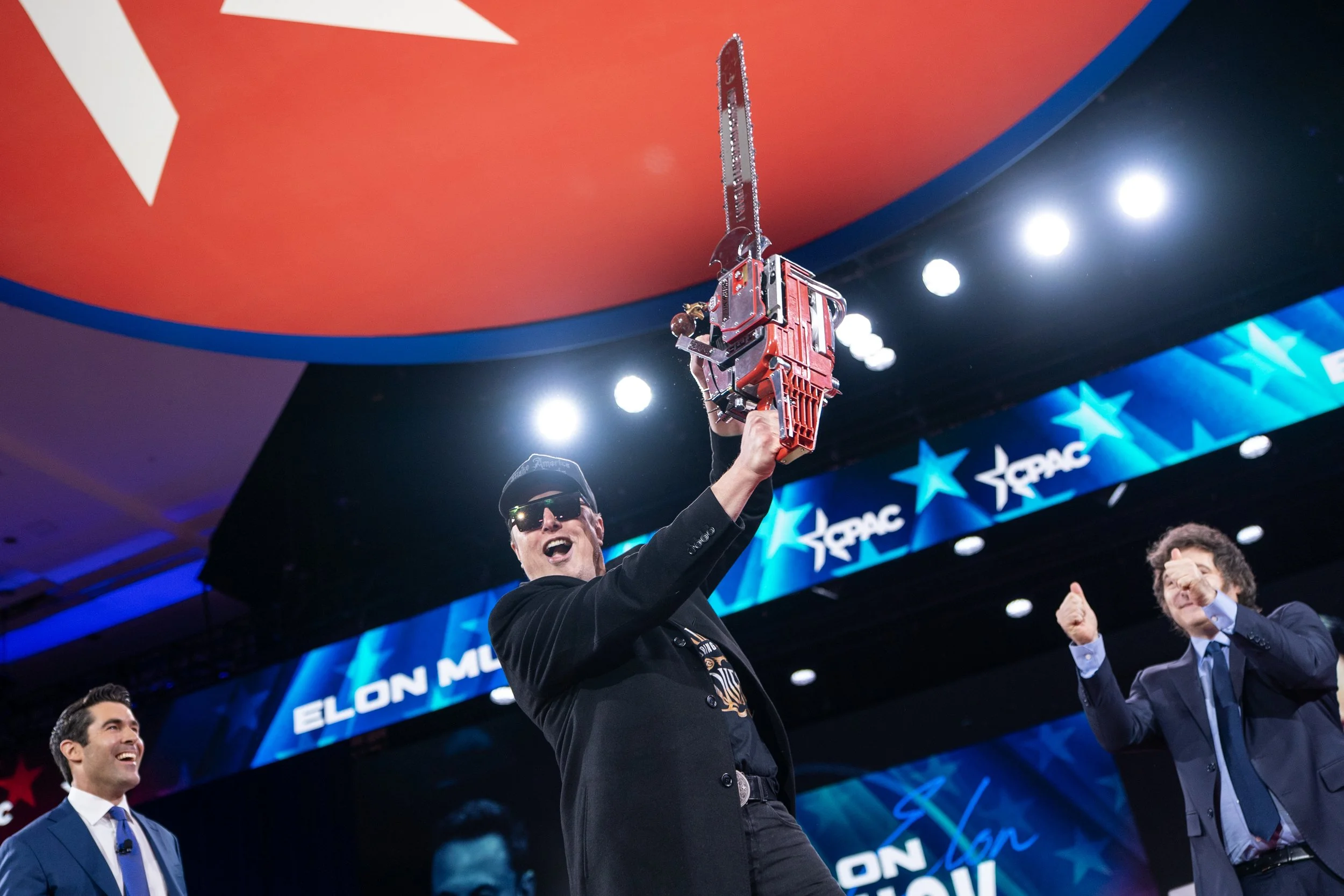  Elon Musk holds a chainsaw onstage as he attends the Conservative Political Action Conference (CPAC) in National Harbor, Maryland, U.S., February 20, 2025. 