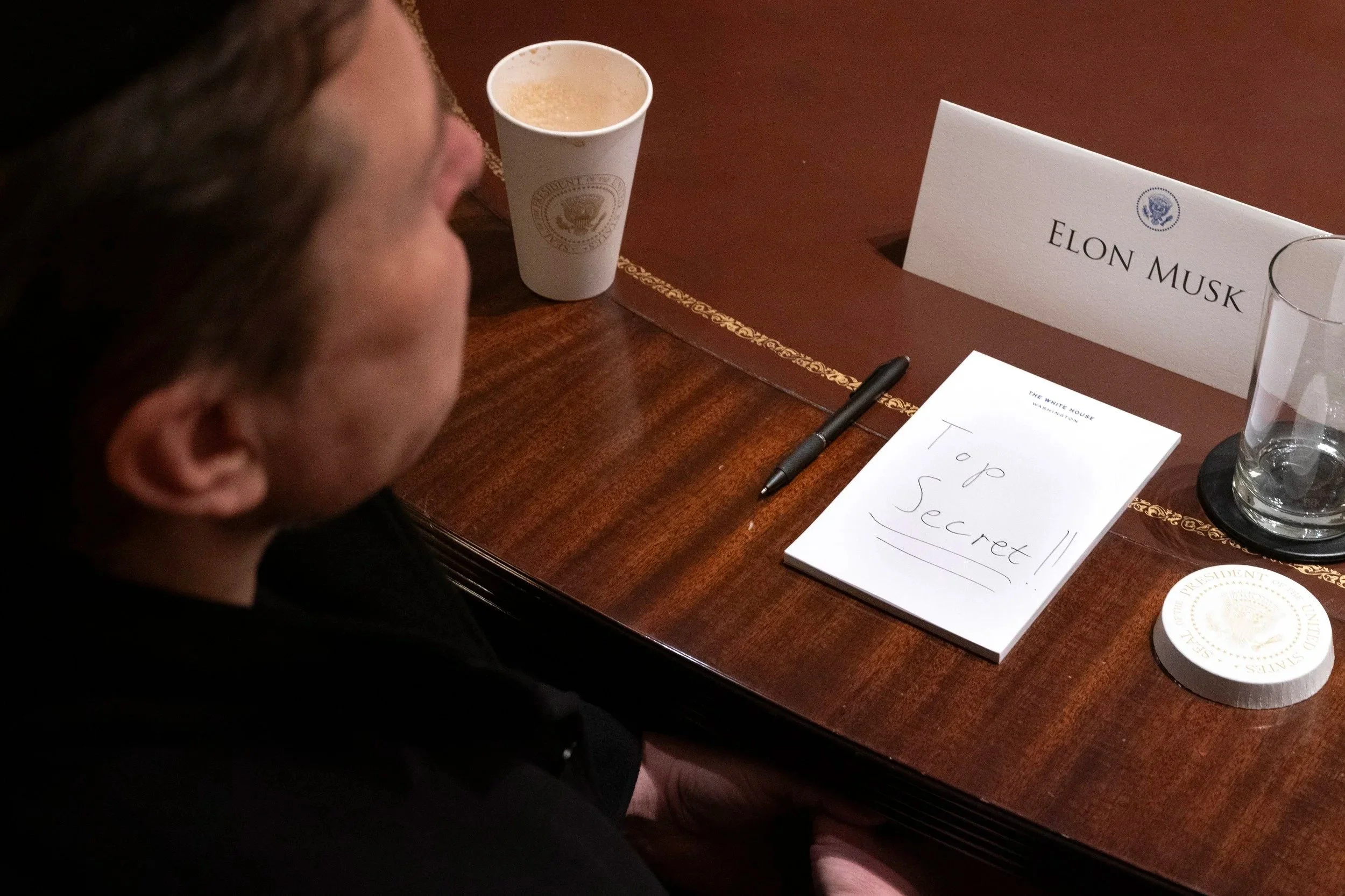 A view shows a hand-written note reading "Top Secret" in front of Tesla CEO Elon Musk as he attends a cabinet meeting at the White House in Washington, D.C., U.S., April 10, 2025. 
