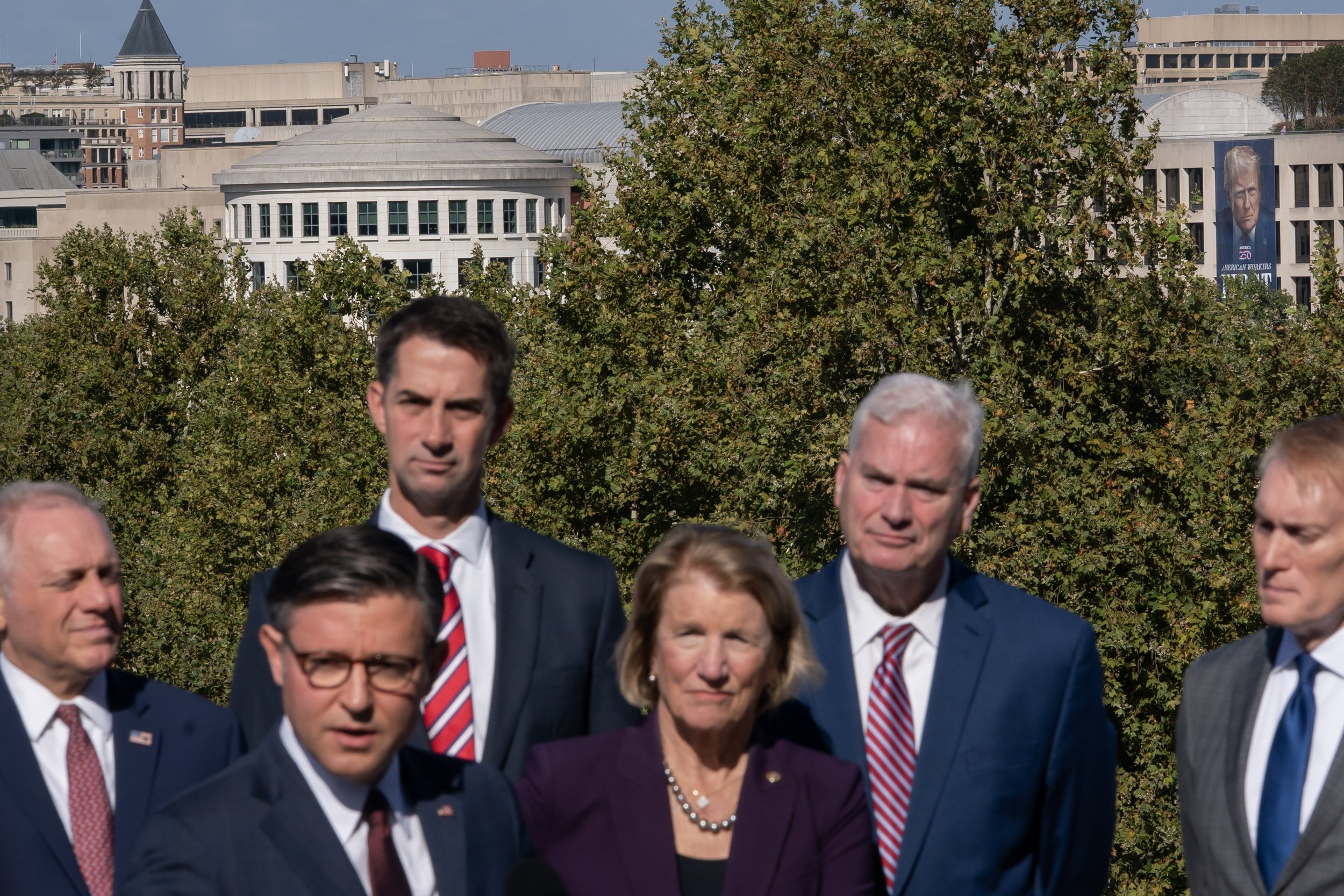  A banner with an image of U.S. President Donald Trump is visible in the background, as Speaker of the House Mike Johnson (R-LA) and other fellow Republicans attend a press conference, on the first day of a partial government shutdown, at the U.S. Ca