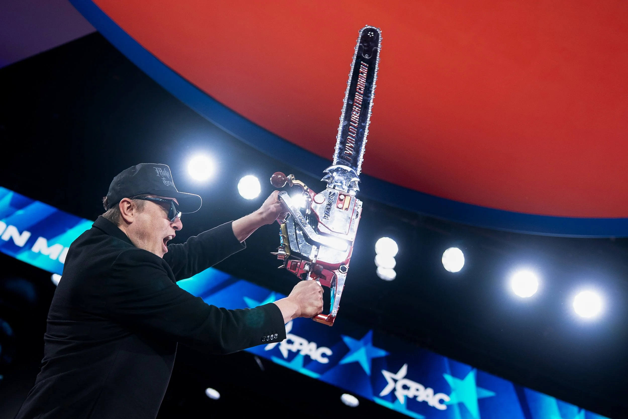  Elon Musk holds a chainsaw onstage as he attends the Conservative Political Action Conference (CPAC) in National Harbor, Maryland, U.S., February 20, 2025. 