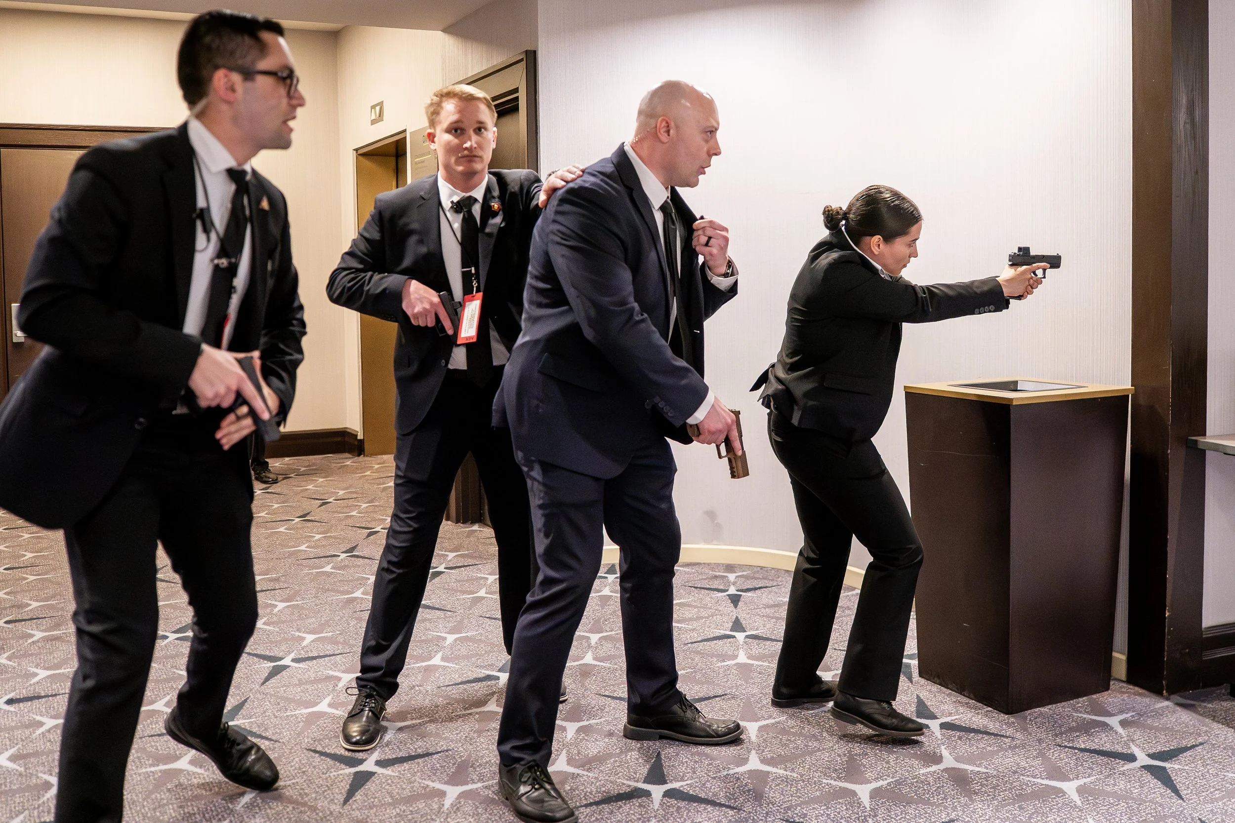  Members of the U.S. Secret Service draw their weapons after a gunman ran through a security checkpoint as President Donald Trump was attending the annual White House Correspondents Association Dinner April 25, 2026 in Washington, DC. 