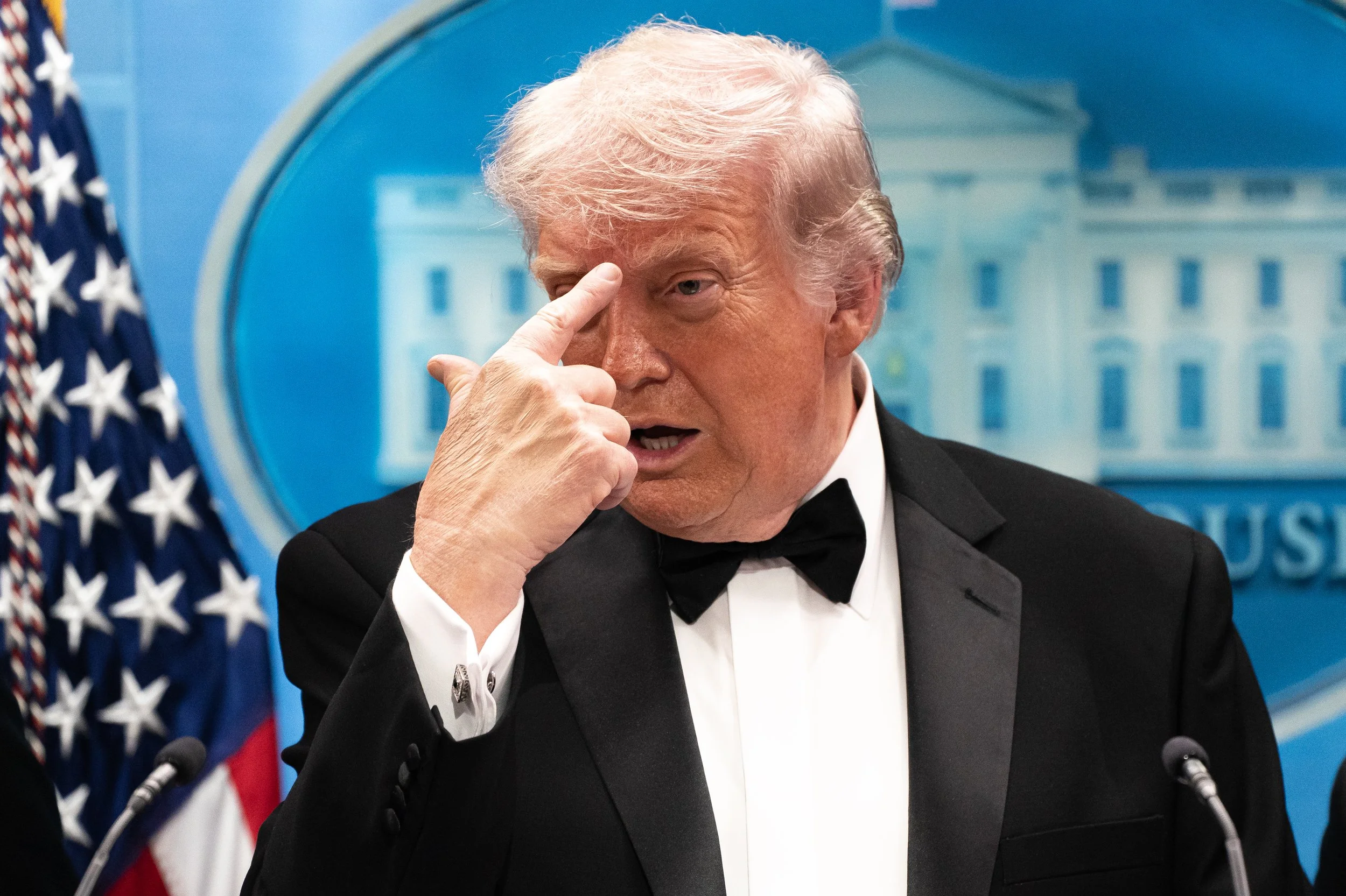  U.S. President Donald Trump points to his forehead while referencing the Butler, Pennsylvania assassination attempt against him during a press conference following gunfire at the White House Correspondence Association dinner in the White House on Ap
