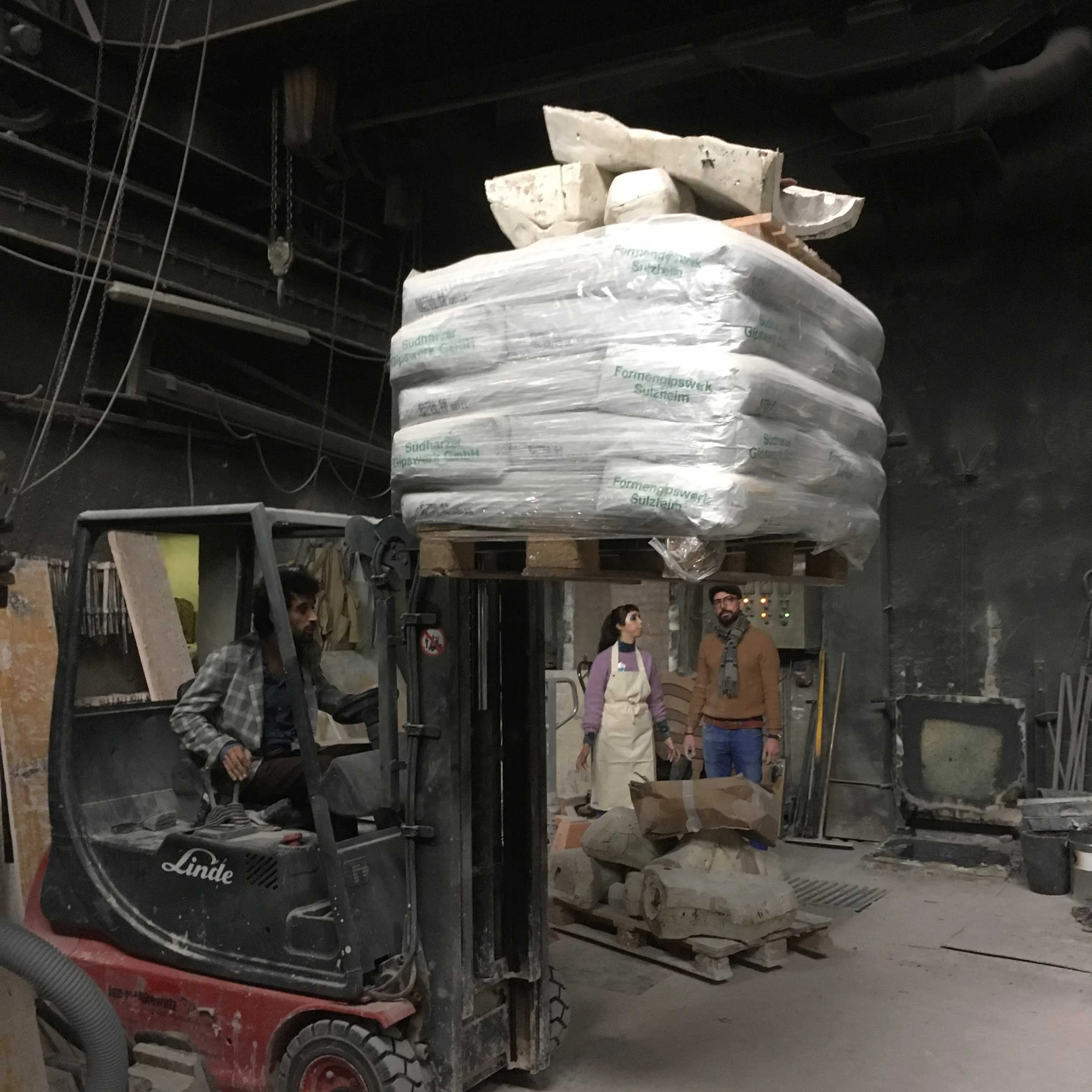 Moving massive pallets of plaster to create our table.