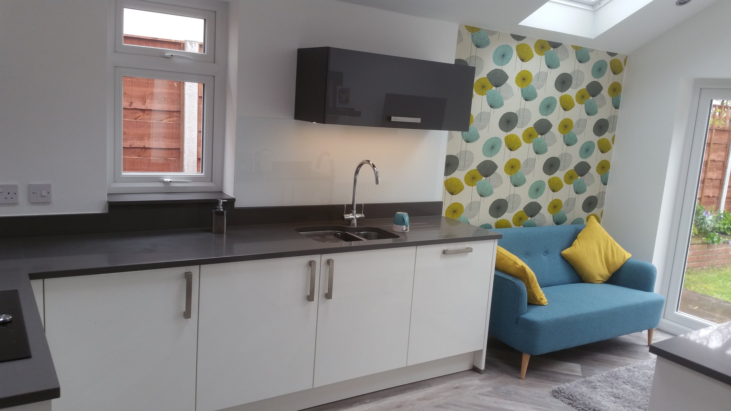 This is a family room now, with practical places and social spaces. Somewhere to do work in the kitchen, and somewhere to relax.