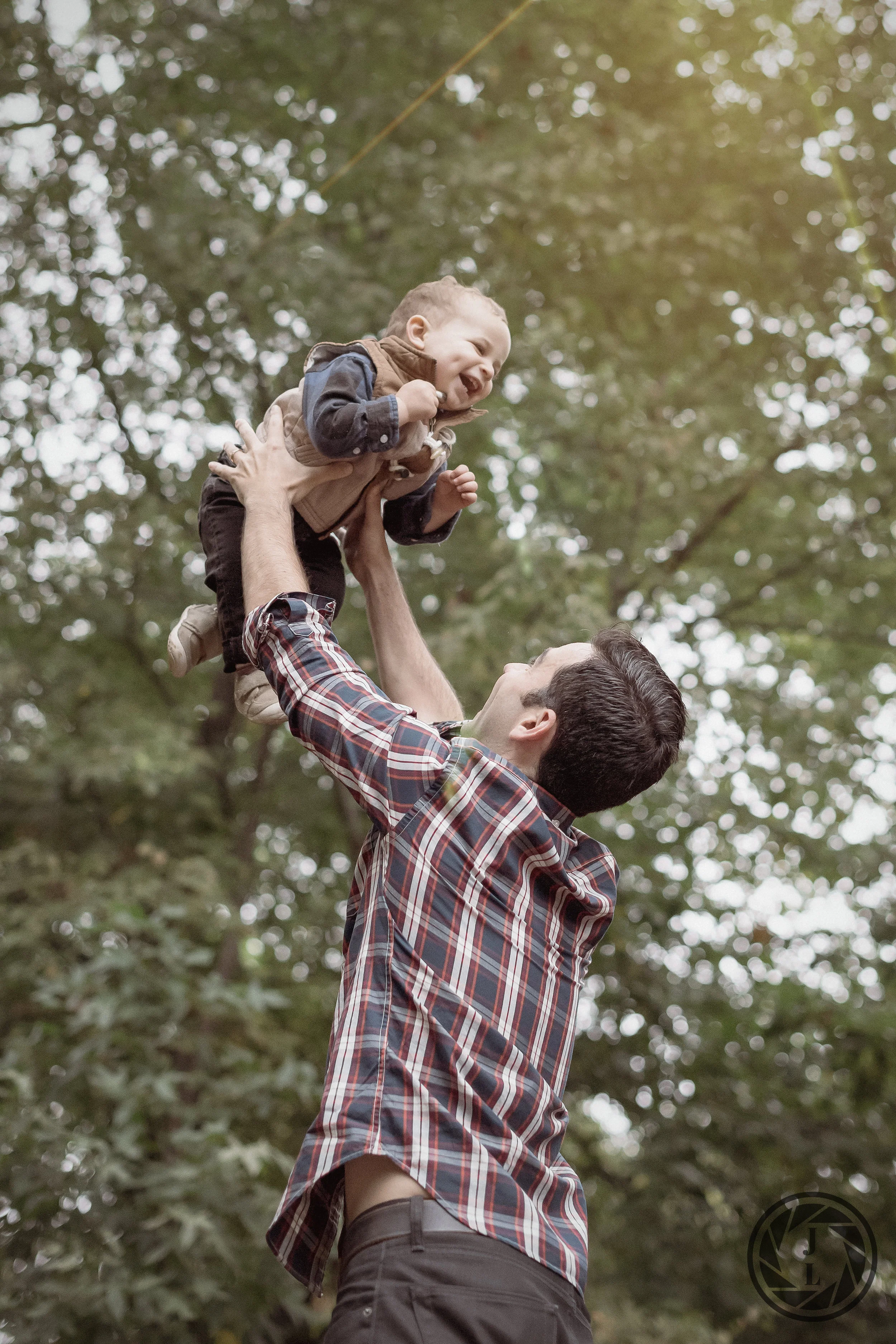 A father tossing his laughing son in the air