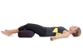 Use a pillow to keep your back flat and relaxed.