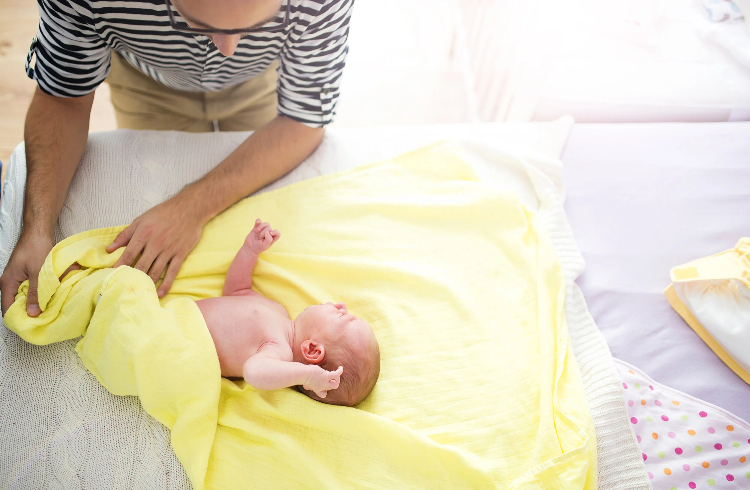 graphicstock-fatther-changing-and-dressing-up-baby-they-are-on-the-bed-at-home_BRc1C83W-.jpg