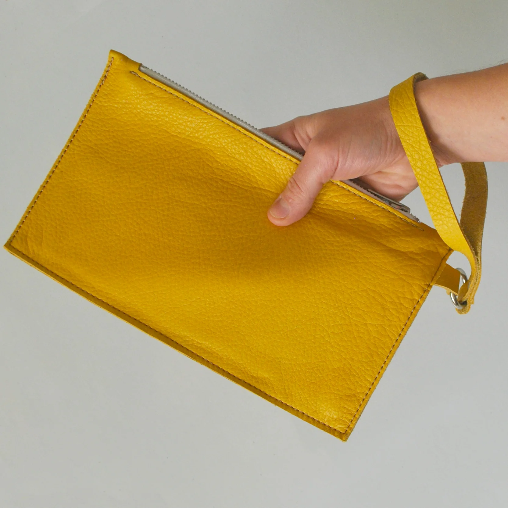 clutch_yellow_hand_sq.jpg