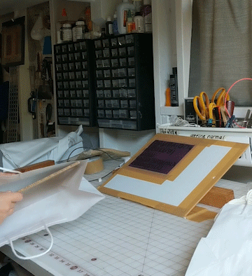 I tuck a 1/4” board in my bag to give it a flat surface to print onto, then line it up, drop my screen down and go. I also “hinged” my screen with a couple smaller pieces of plasticor that I just taped down on my table and taped to the screen frame to save time and help with alignment.