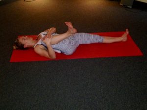 Lying on your back, bring one knee in towards your armpit, flex both of your feet to keep your spine long. Hold for at least 30 seconds then switch sides.