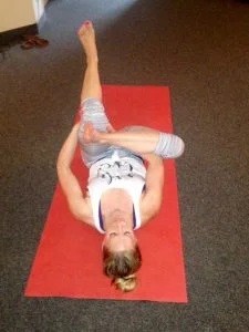 Lying on your back, bend both knees to plant the sole of your left foot on the floor. Place the outside of your right foot on your left thigh and reach your arms through the figure 4 to hang onto your left hamstring. Pull your left thigh closer towards your body to accentuate the stretch in your right outer hip. Hold stretch for at least 30 seconds and repeat on the other side.