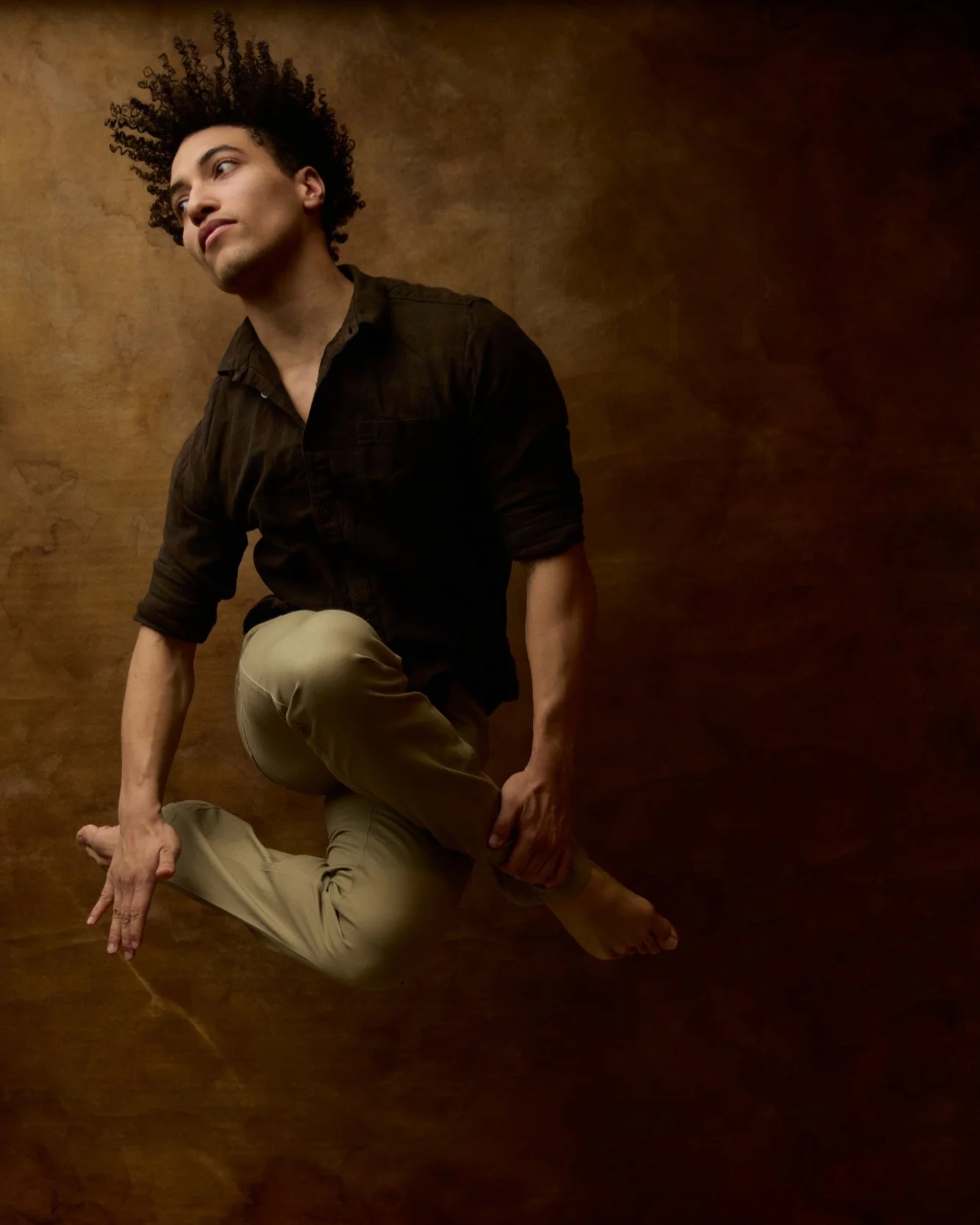 Dancer Odin captured mid-jump at the Garden City studio