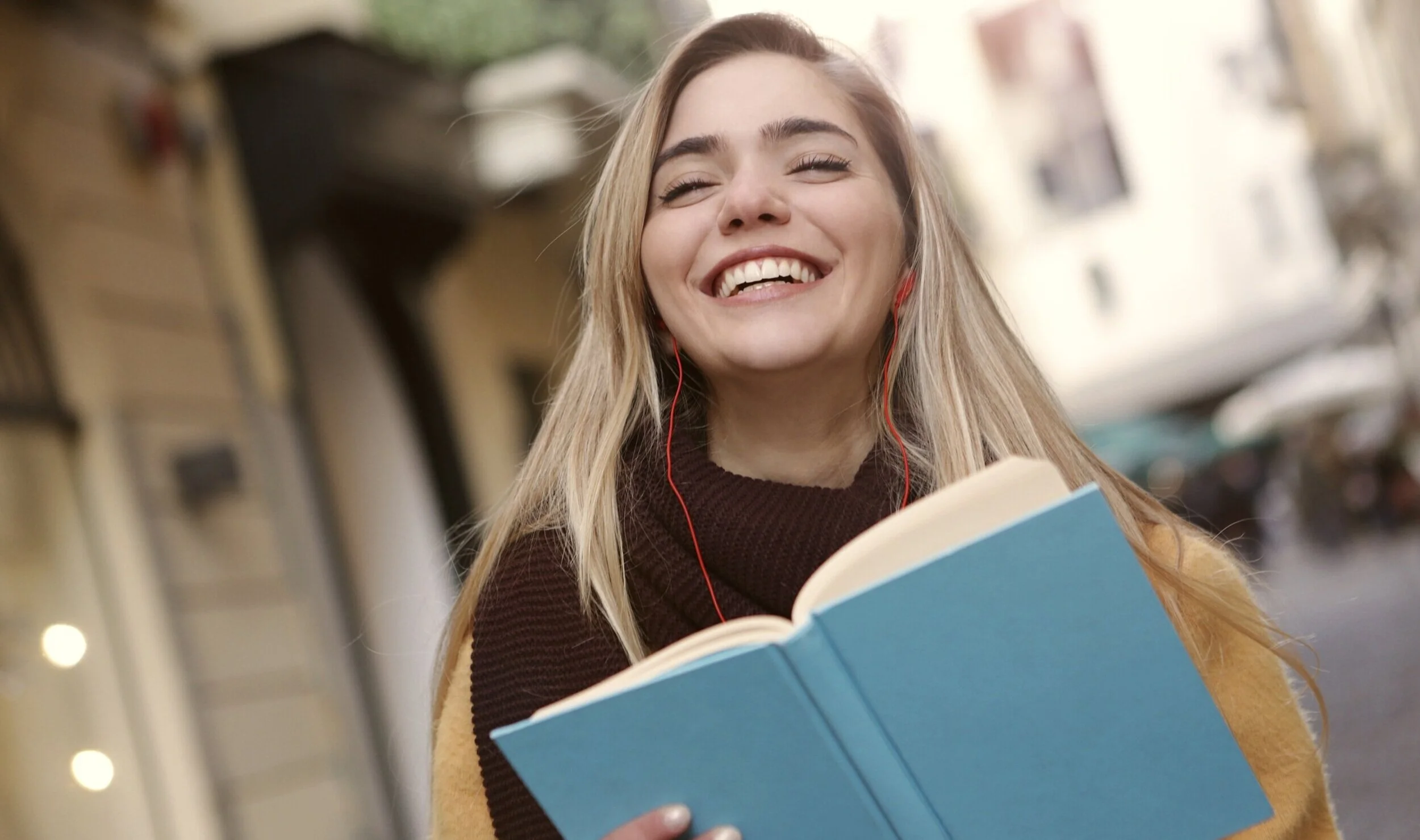 smiling-woman-in-black-and-yellow-long-sleeve-shirt-holding-3781529.jpg