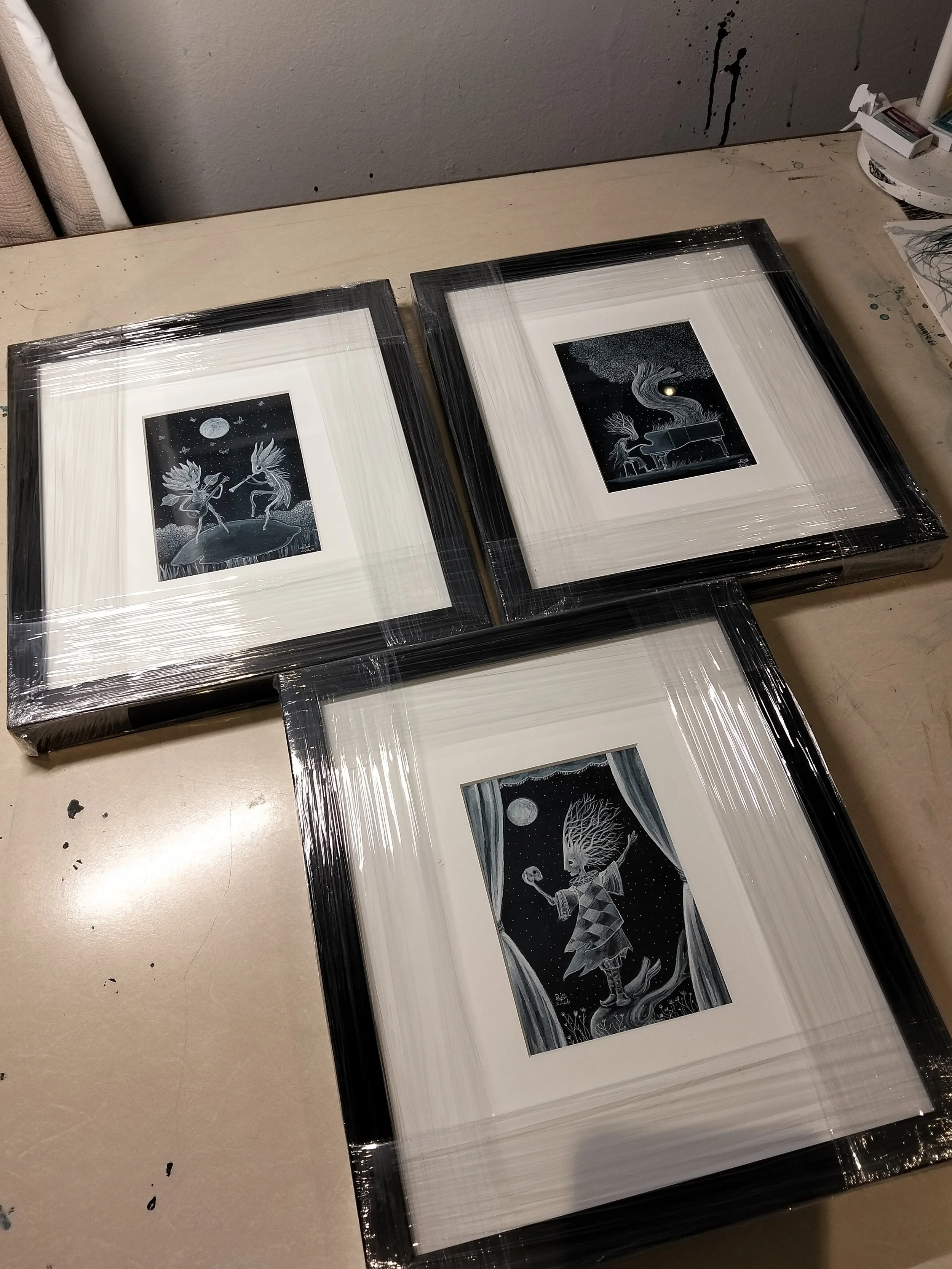  Examples of small ink and gouache artworks framed in black  