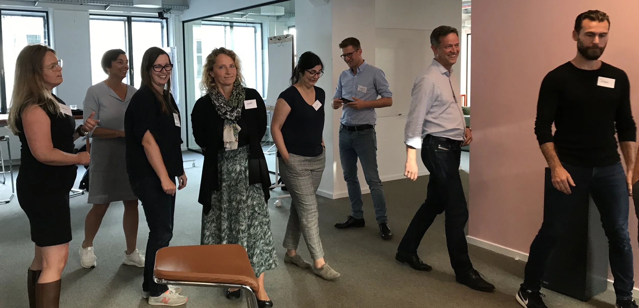 Participants walking in an office space in Copenhagen.