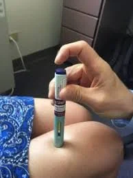 Giving Aimovig autoinjector subcutaneous shot.