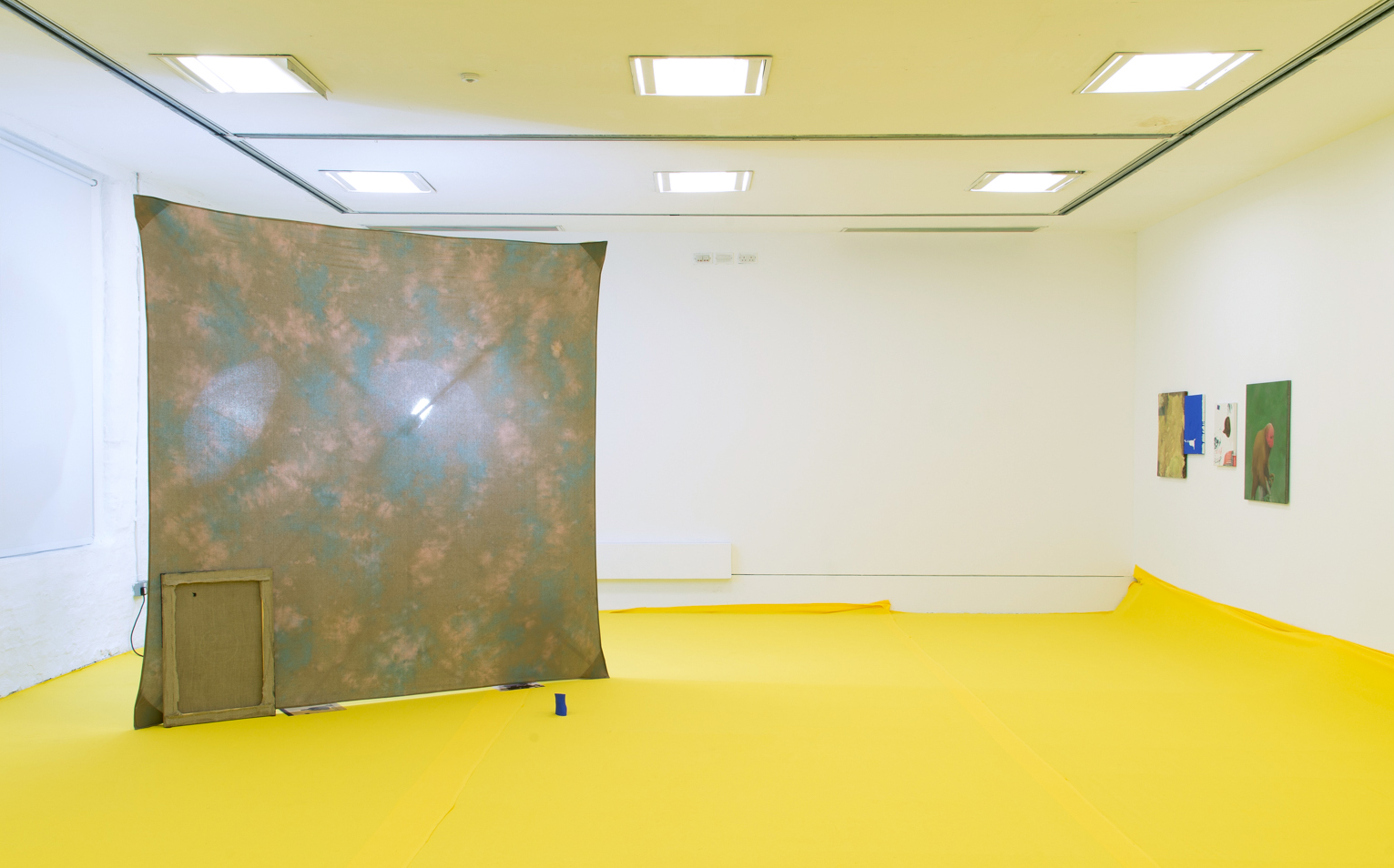  Installation view of 'Do U Feel Like We Do? at Intermedia Gallery, CCA Glasgow 2014. (Cotton, X-frame, photographic background, studio lights, towels, oil paint, turntable, amplifier, speakers, silicon gel bracelets, screws, inkjet prints, coins, pl