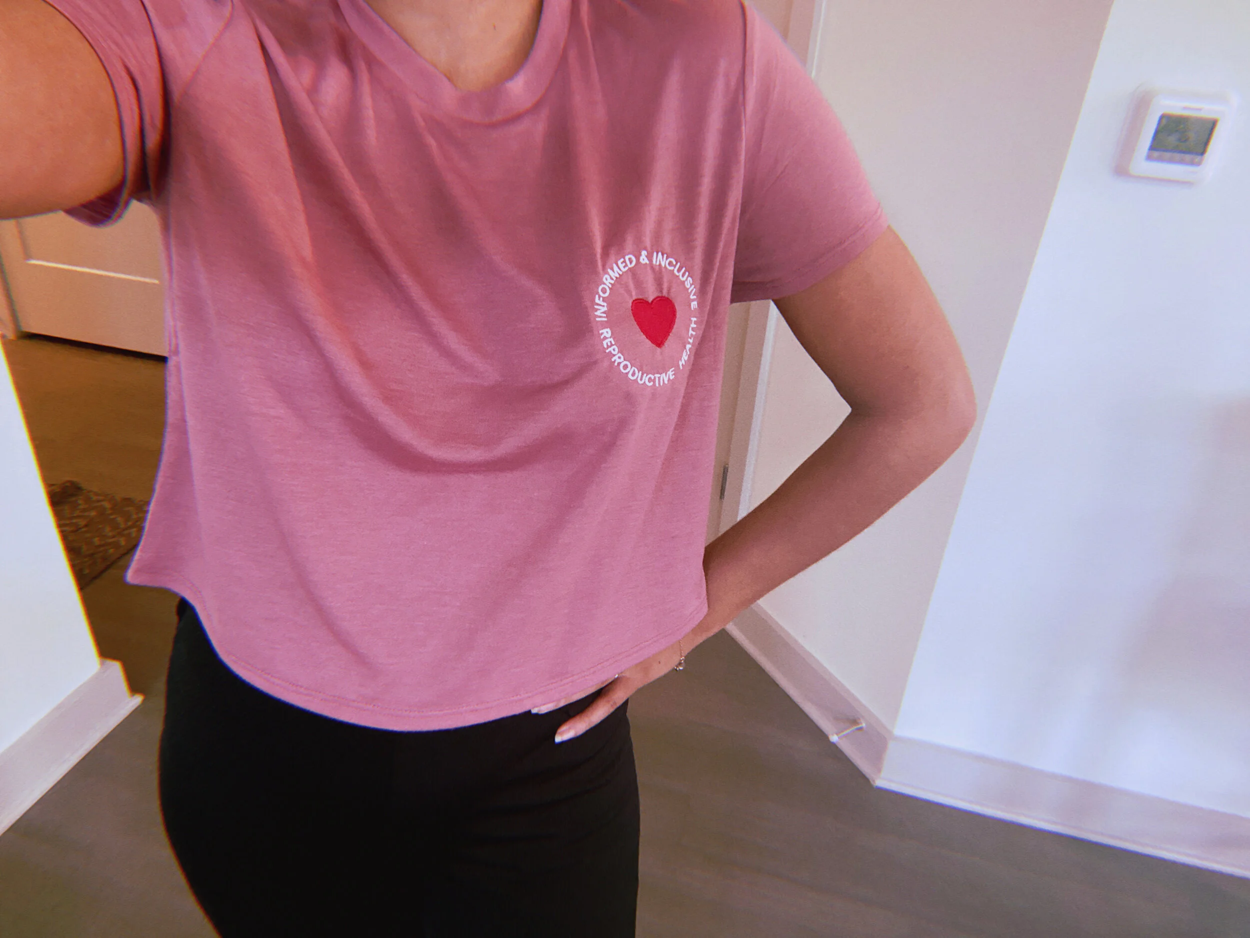 Mauve Informed & Inclusive Reproductive Health Embroidered T-Shirt on a person