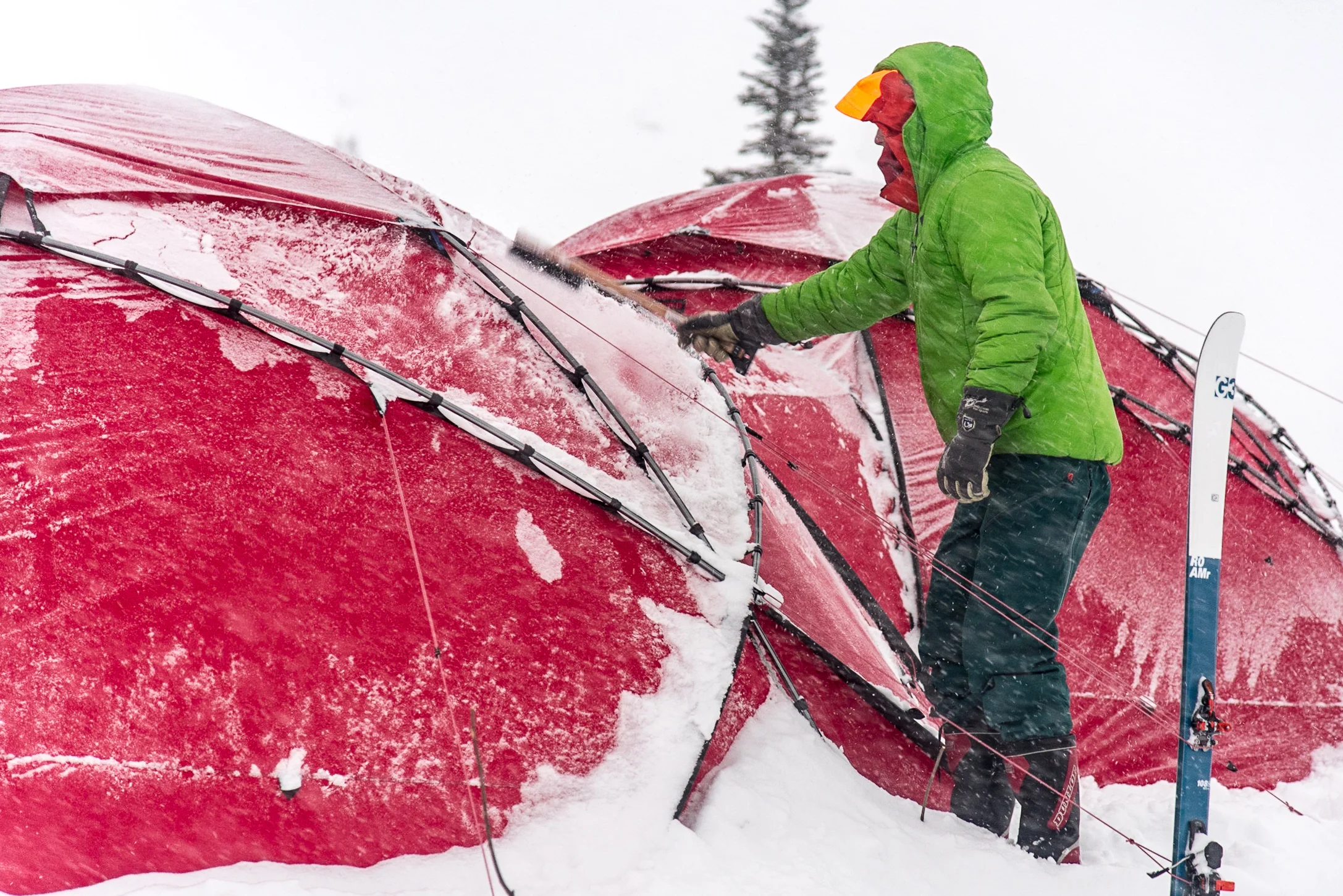 Keeping the tents snow free in a big storm. Photo Phil Tomlinson.