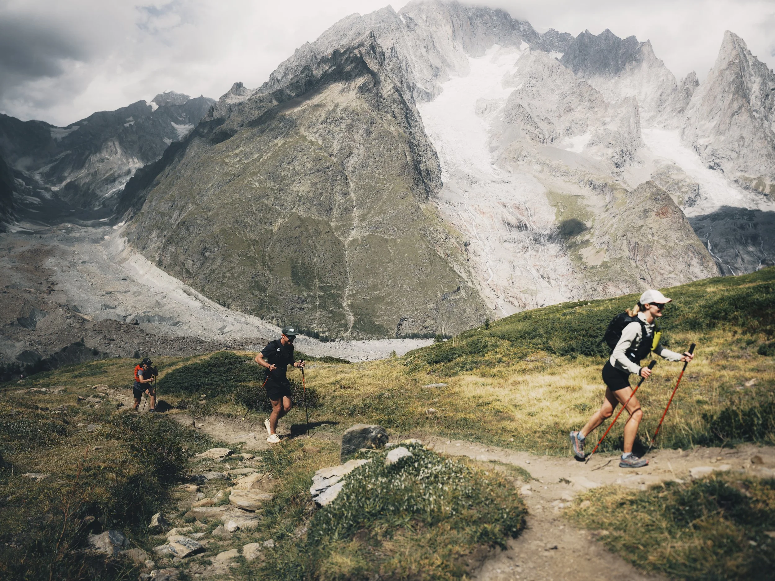 trail runners power hike up grand col ferret on their tour du mont blanc runcation