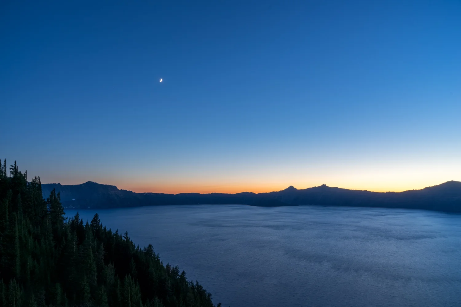 Sunset over the Crater Lake rim. Crater Lake is nearly 5 miles across and 2000 feet deep. There are no rivers or streams that feed it. All the water comes from the 500 inches of snow it gets each year!