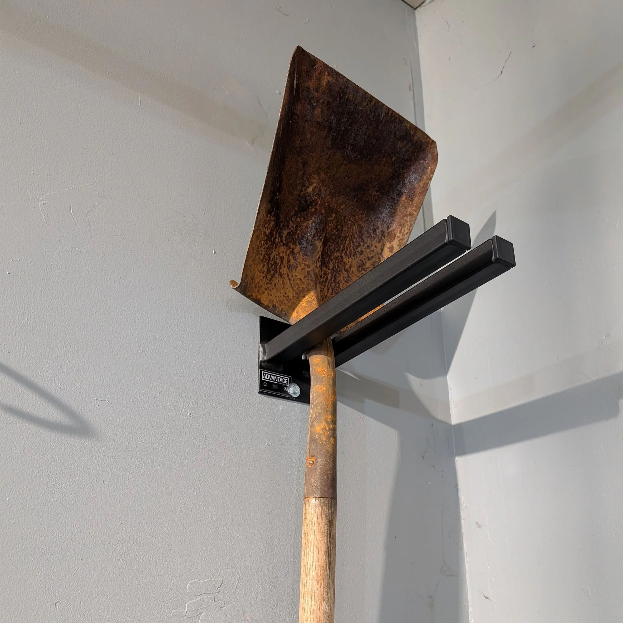 12-inch double prong tool rack in textured black powder coat holding a shovel - Made in USA by Advantage Outdoor Products