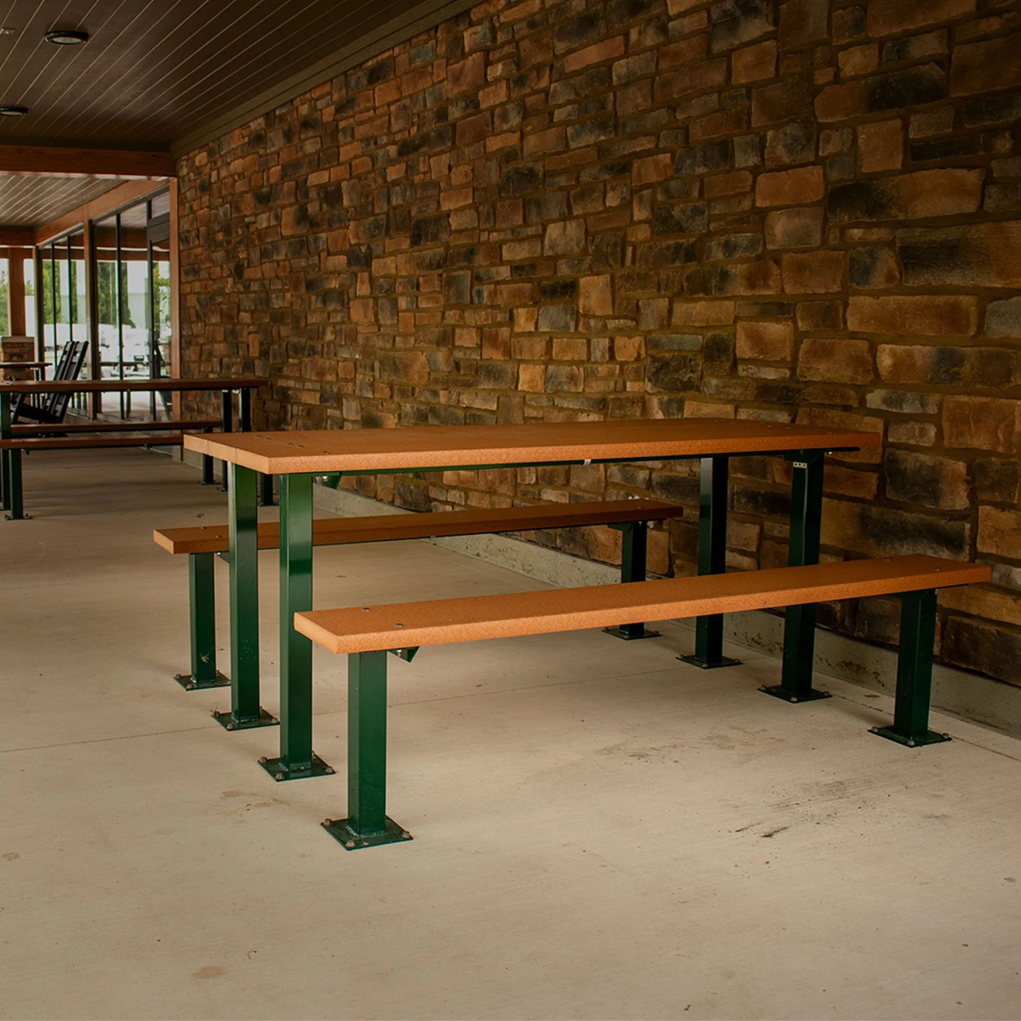 6' Cambridge Picnic Table with cedar top and green steel frame installed at stone pavilion