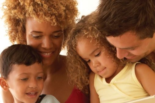 Family%2Breading%2Bfrom%2BProgram%2BGuide.jpg